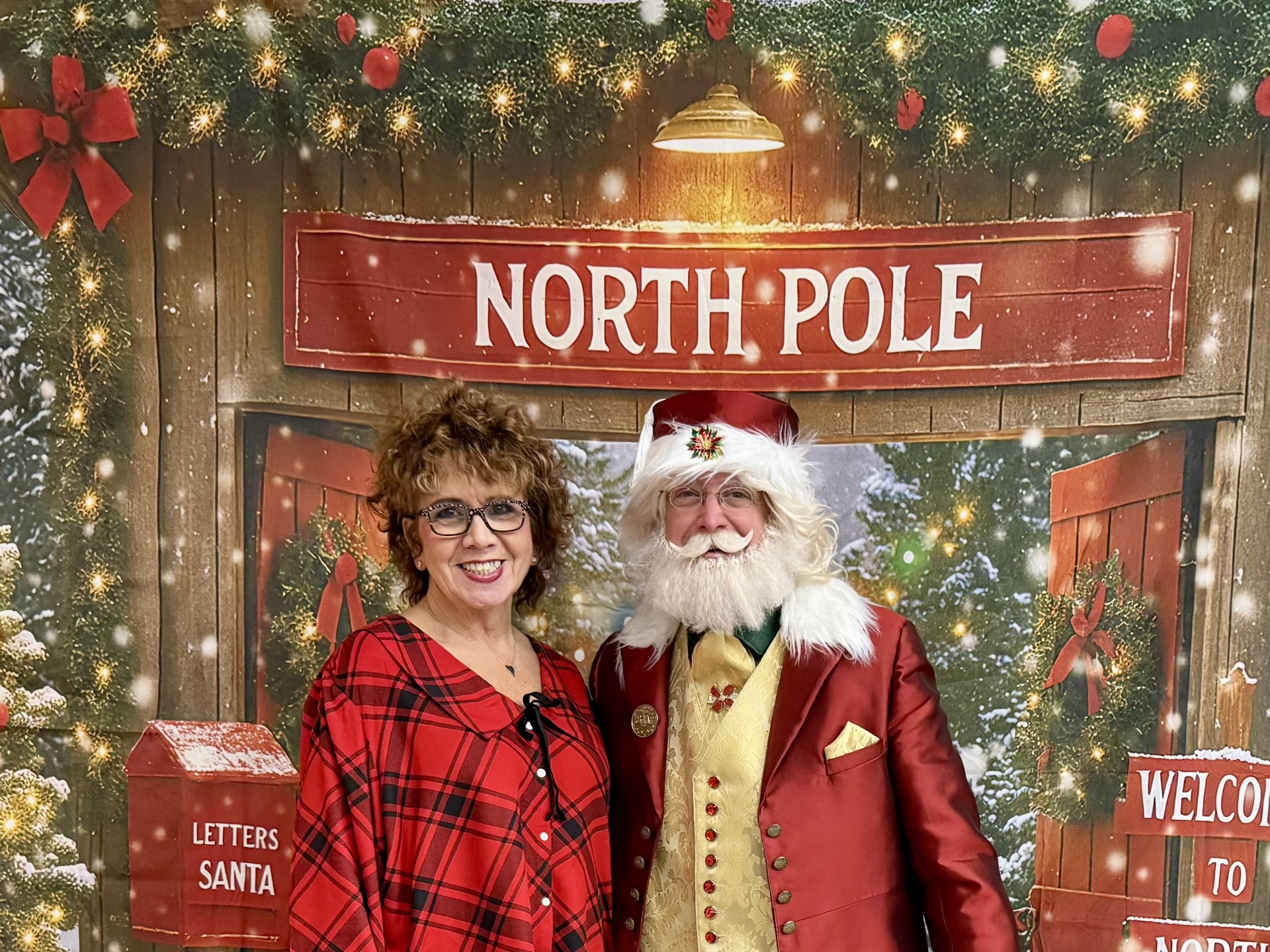 Diane Pudney with Santa Claus at the 2025 Holiday Dinner.